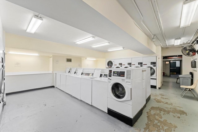 clothes washing area featuring stacked washer and dryer and washer and clothes dryer