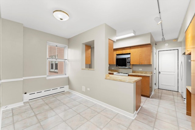 kitchen featuring kitchen peninsula, track lighting, white range, baseboard heating, and light tile patterned floors