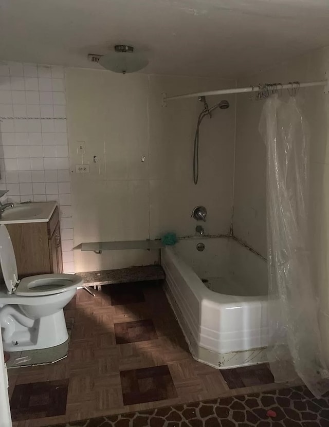 full bathroom with shower / tub combo, vanity, tile walls, parquet flooring, and toilet