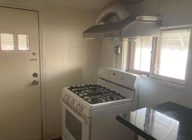 kitchen featuring island exhaust hood and gas range gas stove