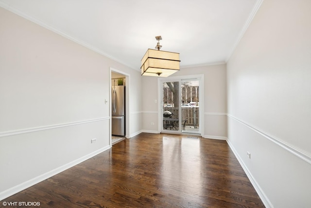 empty room featuring crown molding and dark hardwood / wood-style flooring