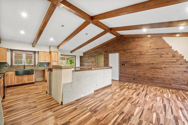 kitchen featuring light brown cabinets, decorative backsplash, sink, and light wood-type flooring