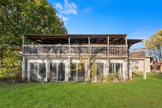 rear view of property with a yard and a deck