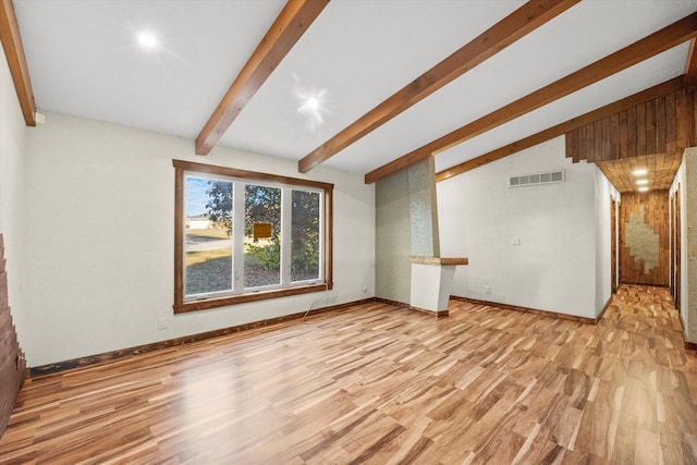 unfurnished living room with light hardwood / wood-style flooring and vaulted ceiling with beams