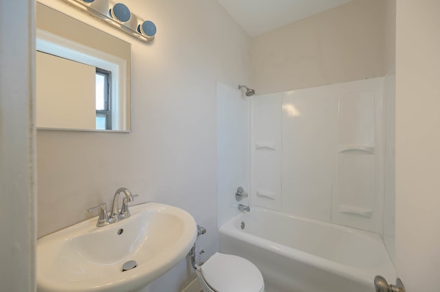 bathroom with  shower combination, a sink, and toilet