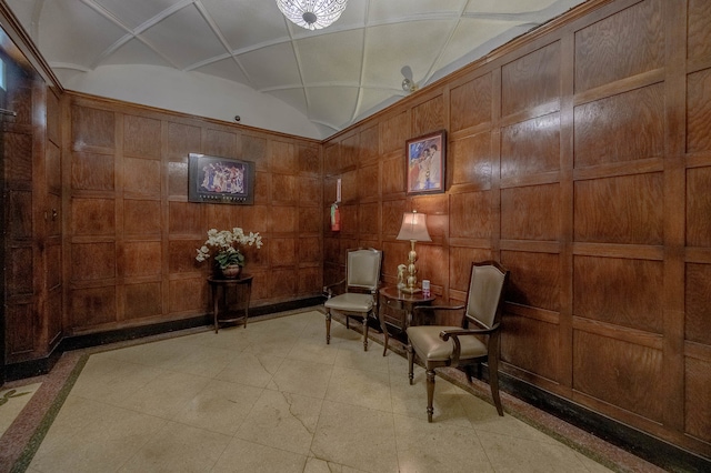 living area with wood walls and vaulted ceiling