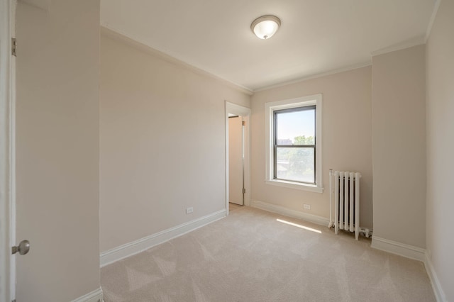 unfurnished room featuring baseboards, ornamental molding, light carpet, and radiator