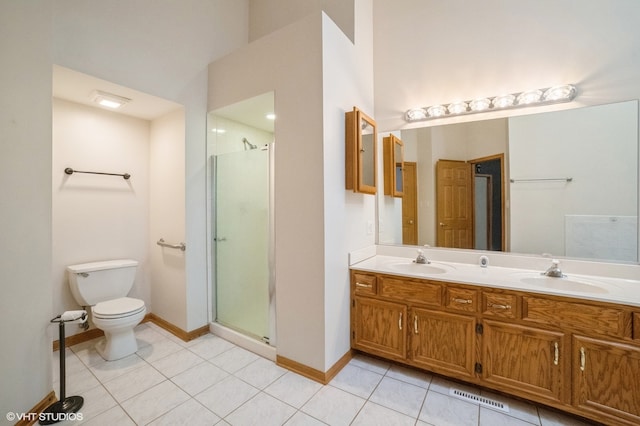 bathroom featuring vanity, a shower with door, tile patterned flooring, and toilet