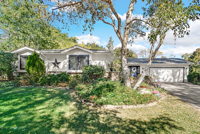 ranch-style home with a garage and a yard