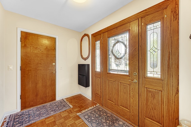 foyer entrance with light parquet flooring