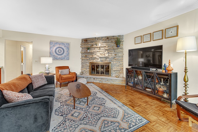 living room with a stone fireplace and parquet flooring