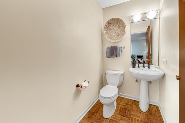 bathroom with parquet flooring and toilet