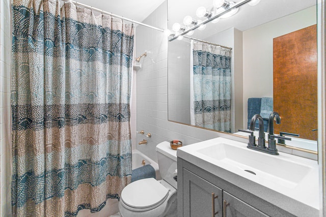 full bathroom with shower / bath combo with shower curtain, vanity, and toilet