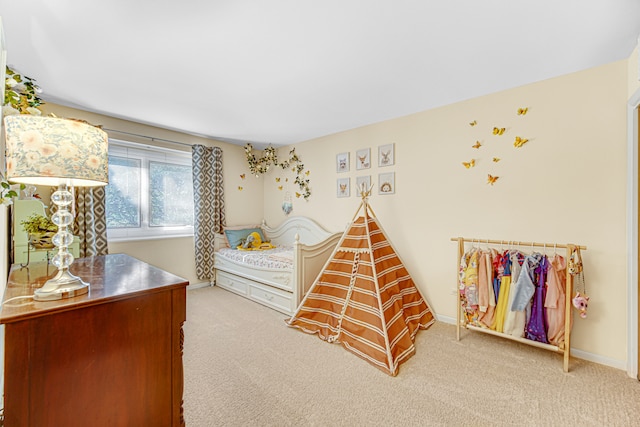 bedroom featuring light carpet