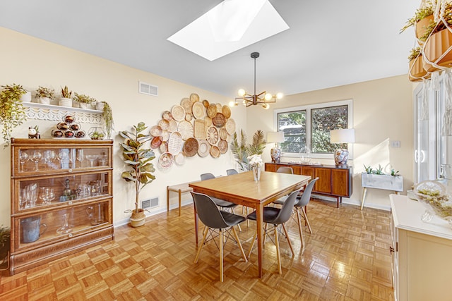 dining area featuring a skylight, light parquet floors, and a notable chandelier