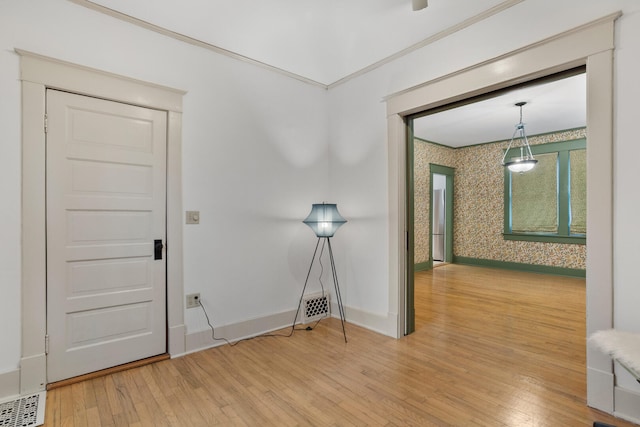 corridor featuring hardwood / wood-style floors and crown molding