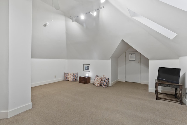 bonus room featuring carpet, ceiling fan, and vaulted ceiling with skylight