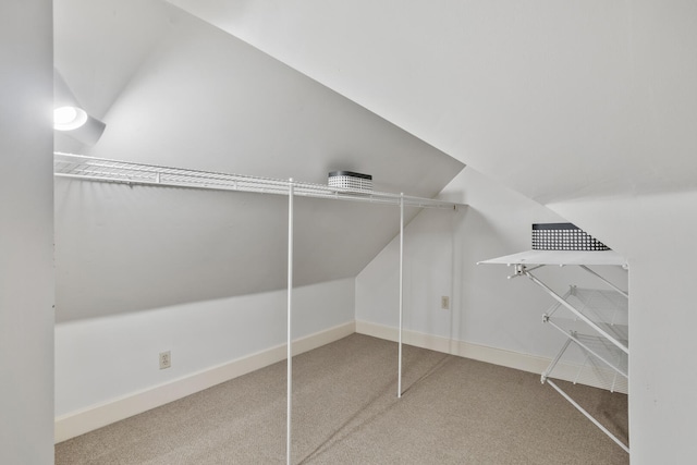 spacious closet featuring carpet flooring and lofted ceiling