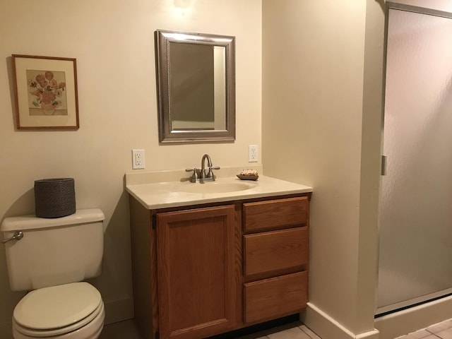 bathroom with tile patterned flooring, vanity, and toilet