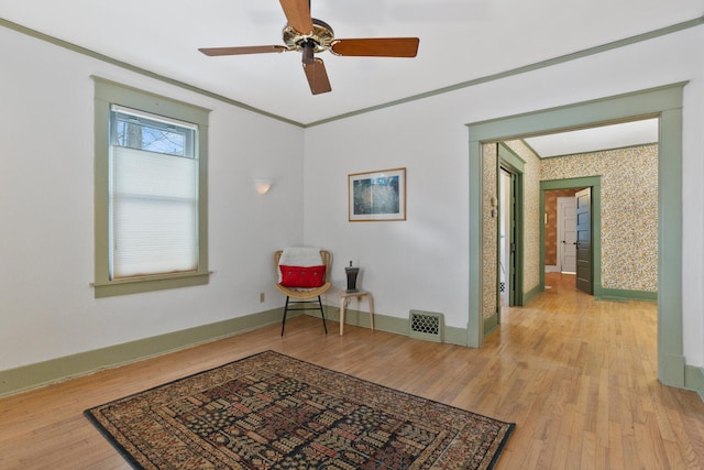 sitting room with ceiling fan, light hardwood / wood-style flooring, and ornamental molding