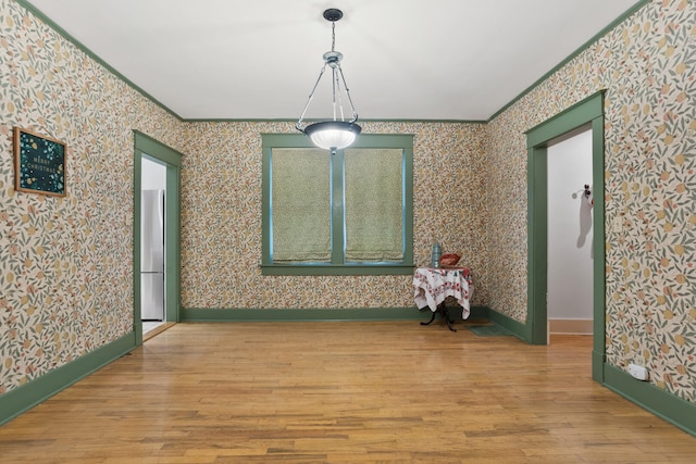 interior space featuring light wood-type flooring and crown molding