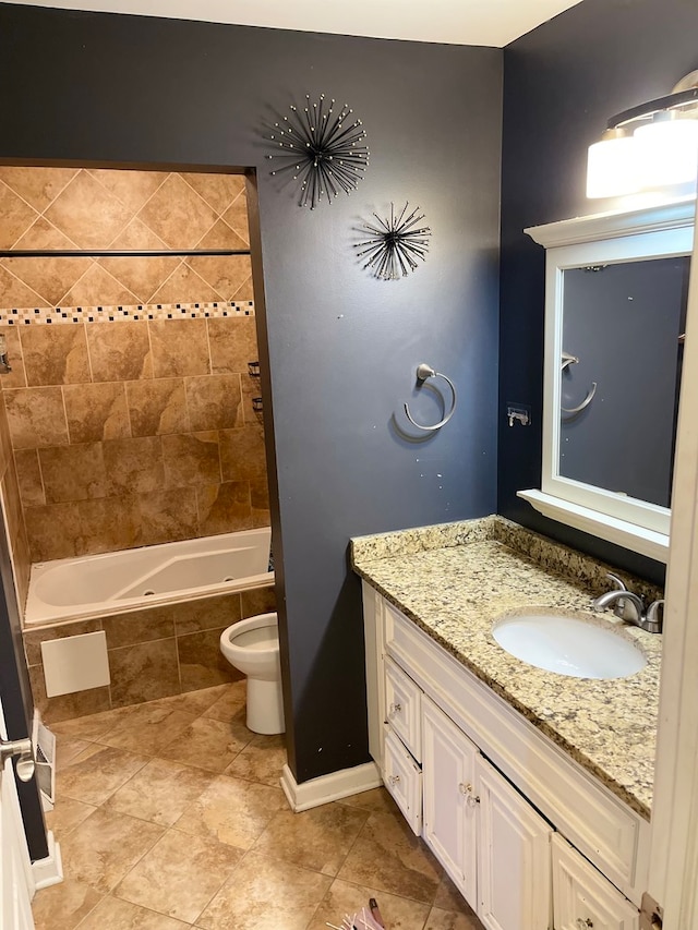 full bathroom featuring vanity, tiled shower / bath combo, and toilet