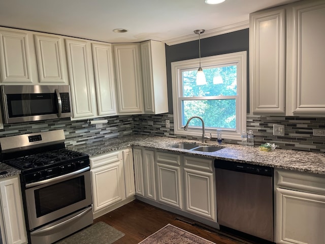 kitchen featuring dark hardwood / wood-style floors, sink, white cabinets, appliances with stainless steel finishes, and light stone counters