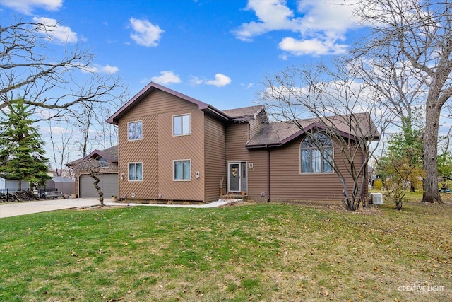 view of front of home featuring a garage and a front lawn