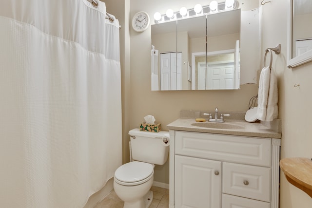 bathroom featuring vanity, toilet, and tile patterned floors