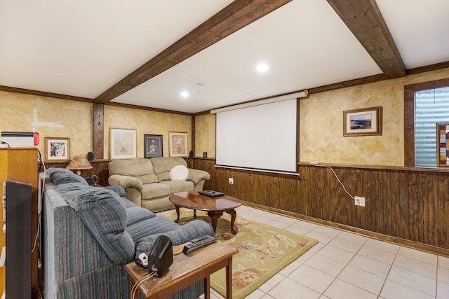 tiled cinema room featuring beamed ceiling and wood walls