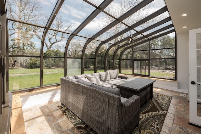 sunroom featuring vaulted ceiling