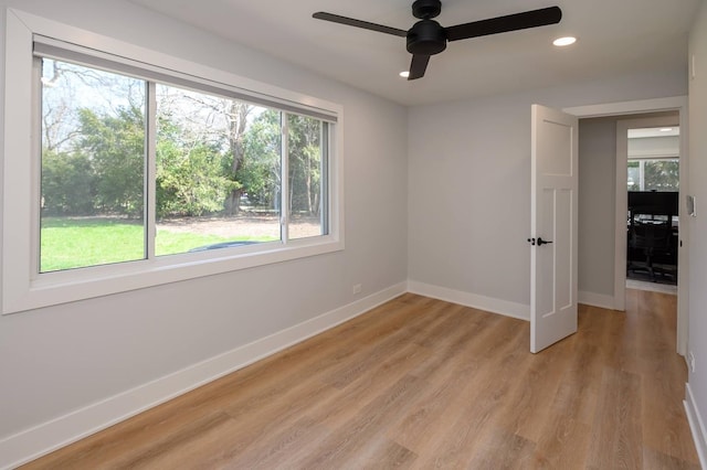 unfurnished room with ceiling fan and light hardwood / wood-style floors