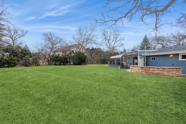 view of yard featuring glass enclosure