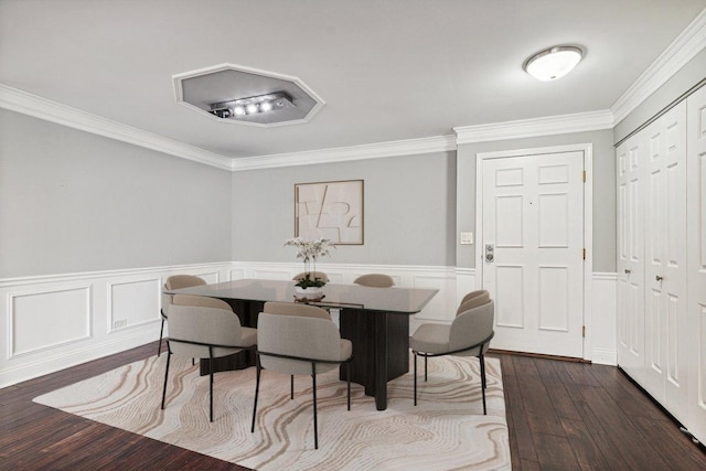 dining space featuring ornamental molding and dark wood-type flooring