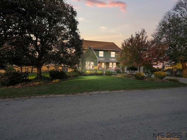 view of property hidden behind natural elements with a lawn