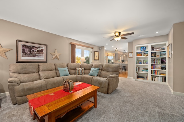 living room featuring ceiling fan and carpet