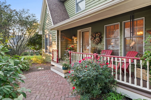 view of exterior entry featuring covered porch