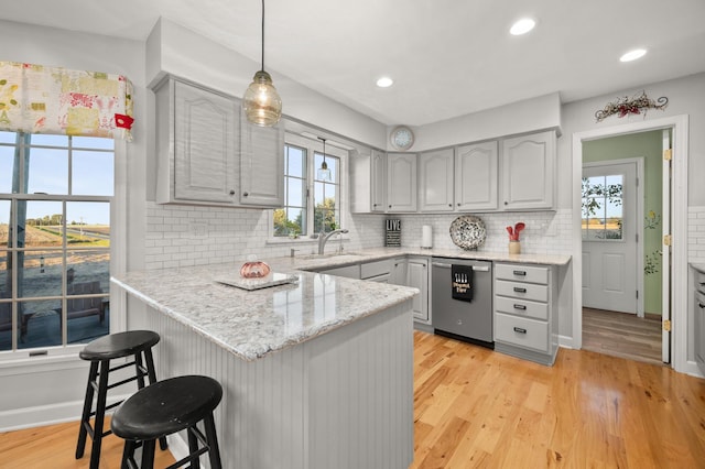 5995 W Clare Rd, Clare, IL 60111 - kitchen with dishwasher, a peninsula, a kitchen bar, gray cabinets, and recessed lighting