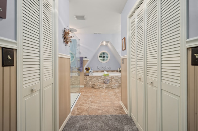 hall featuring light tile patterned floors