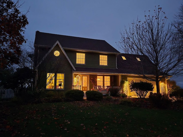 view of front of property with a porch and a front lawn