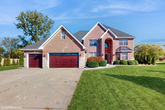 view of front of property featuring a front yard and a garage