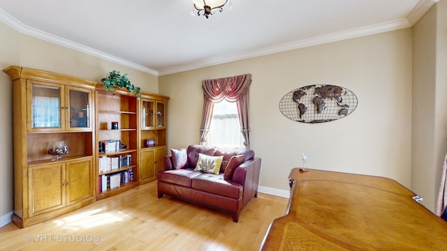 living area with ornamental molding and light hardwood / wood-style floors