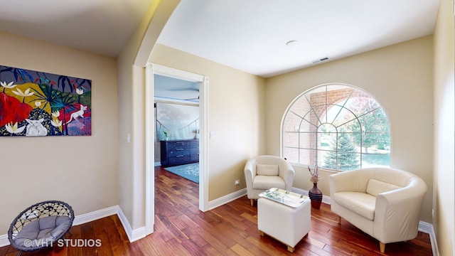 sitting room with dark hardwood / wood-style flooring