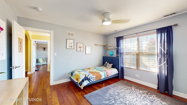 bedroom with dark hardwood / wood-style floors and ceiling fan