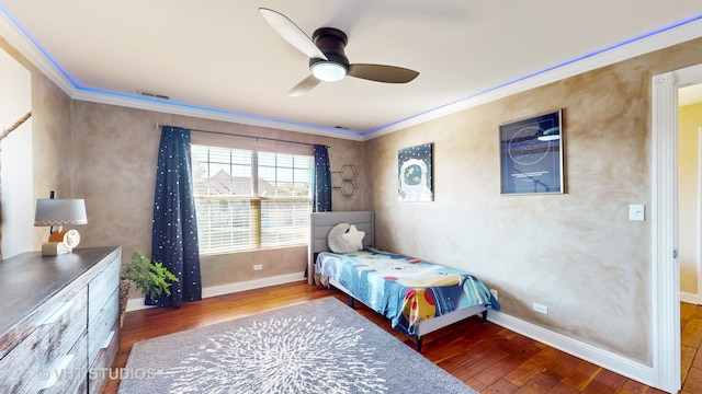 bedroom featuring ornamental molding, hardwood / wood-style flooring, and ceiling fan