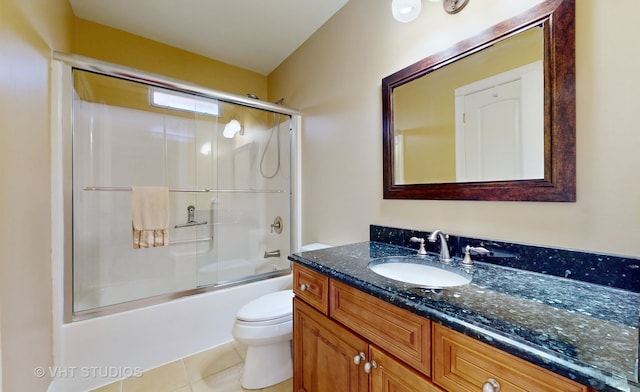 full bathroom with vanity, combined bath / shower with glass door, toilet, and tile patterned floors