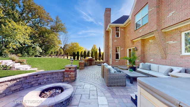 view of patio / terrace with an outdoor living space with a fire pit