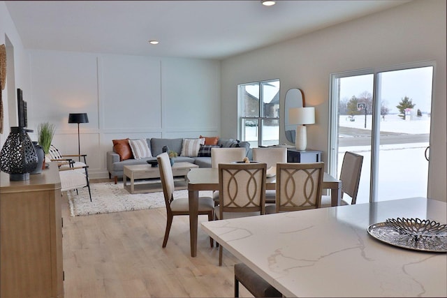 dining area featuring a wealth of natural light and light hardwood / wood-style flooring