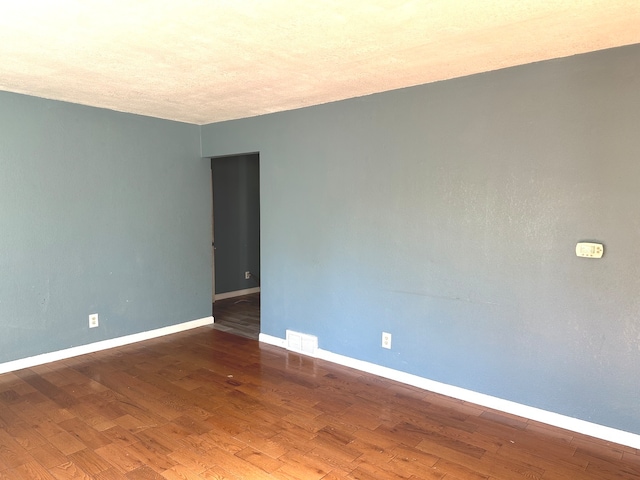 unfurnished room featuring wood-type flooring