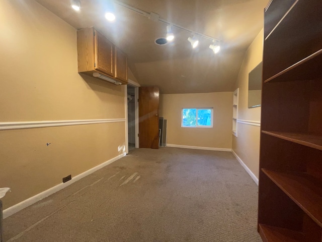 interior space with rail lighting and carpet floors